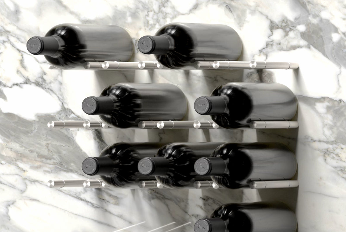 Partially filled wall-mounted metal wine pegs holding seven bottles on a marble wall